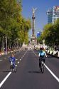 Bicyclists ride on the Paseo de la Reforma with no traffic on a Sunday in Mexico City, Mexico.