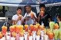 Young Mexican street vendors selling fresh fruit cups in Mexico City, Mexico.