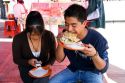 Mexican man eating a gordita in Mexico City, Mexico.