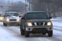 Automobiles driving on snow covered roads in Boise, Idaho.