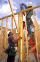 Hispanic construction workers framing a new home in Boise, Idaho.