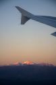 Aerial view of the Andes in Argentina at sunrise through the window of an airplane.