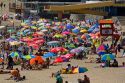 People sit under umbrellas for shade on the beach at Concon, Chile.