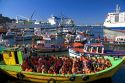 Passengers on a boat tour wearing life jackets in the Port at Valparaiso, Chile.