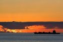 Container ship at sunset in the Pacific Ocean off the coast of Valparaiso, Chile.