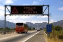 Spanish language road sign reads, Drive With Caution, near Santiago, Chile.