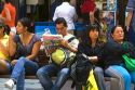 People sit on a bench on the Paseo Ahumada in Santiago, Chile.