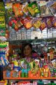 Young girl working in a kiosk selling snacks and magazines in Santiago, Chile.