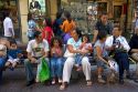 People sit on benches in Santiago, Chile.