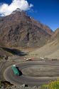 Trucks drive on switchback roads in the Andes Mountain Range in Chile.