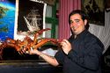 Waiter holding a king crab at a seafood restaurant in Ushuaia, Argentina.