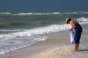 Beachcomber searching for seashells on the beach at Sanibel Island on the Gulf Coast of Florida.