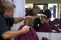 Barber giving a three year old boy a haircut in Tampa, Florida. MR