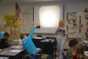 Fourth grade elementary school teacher uses an overhead projector in a classroom in Tampa, Florida.