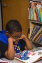 Fourth grade student reads a textbook in a classroom in Tampa, Florida.