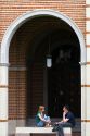 Students sit under an archway at Lovett Hall on the campus of William Marsh Rive University in Houston, Texas. MR