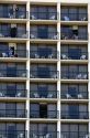 People on balconies of hotel rooms at Galveston Beach in Galveston, Texas.