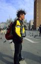 Young Italian man with mohawk hairstyle in the Piazza San Marco at Venice, Italy.