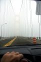 View from the inside of a car crossing the Mackinac Bridge on a foggy day in Michigan.