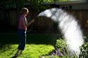 Woman watering flower in Boise, Idaho. MR