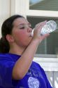 11 year old girl drinking water on a hot summer day in Boise, Idaho. MR