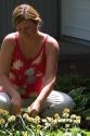 31 year old woman deadheading daisies in the garden, Boise, Idaho. MR