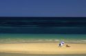 Beach scene with woman and umbrella near Adelaide, Australia.