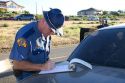 Police officer writing investigation report of a car accident at Kennewick, Washington.