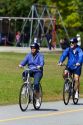 Bicyclists ride along the Seawall path in Stanley Park at Vancouver, British Columbia, Canada.