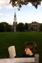 Student reading a book on the campus of Dartmouth College located in the town of Hanover, New Hampshire, USA.