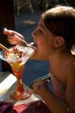 Young girl eating an ice cream sundae at a restaurant in the town of Saint-Jean-de-Luz, Pyrenees Atlantiques, French Basque Country, Southwest France. MR