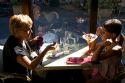 Grandmother and granddaughter dining at a restaurant in the town of Saint-Jean-de-Luz, Pyrenees-Atlantiques, French Basque Country, Southwest France. MR
