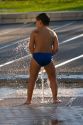Boy playing in a fountain at the Guggenheim Museum in the city of Bilbao, Biscay, Basque Country, northern Spain.