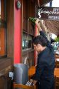 Server pouring cider at a cidereria in the town of Ribadesella, Asturias, northern Spain.