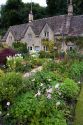 Cotswold stone cottage and garden in Bibury, Gloucestershire, England.