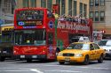 Tourists ride on a double decker bus sightseeing tour in Manhattan, New York City, New York, USA.