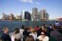 Passengers on a New York Harbor tour boat view Lower Manhattan, New York City, New York, USA.