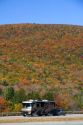 Motorhome traveling through fall foliage in the White Mountain National Forest, Grafton County, New Hampshire, USA.