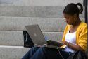 African American female student studying with a laptop on the campus of Harvard University in Cambridge, Greater Boston, Massachusetts, USA. MR