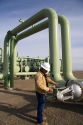Operator turning a valve at a geothermal power plant in Malta, Idaho, USA. MR