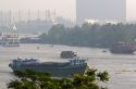 Activity on the Saigon River on a hazy, smoggy morning in Ho Chi Minh City, Vietnam.