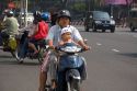 Vietnamese family riding motorbikes in Ho Chi Minh City, Vietnam.