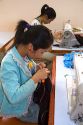 Disadvantaged Vietnamese youth learn to use a sewing machine at a vocational school named Kids First Vietnam in Dong Ha, Vietnam.