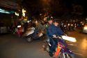 Vietnamese people ride motorbikes in Hanoi, Vietnam.
