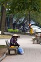 Vendor selling fruit on park benches along the Hoan Kiem Lake in Hanoi, Vietnam.