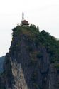 Limestone karast topped with an ancient structure and modern cell phone tower in Ha Long Bay, Vietnam.