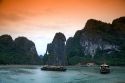 Scenic views of limestone karsts and tourist boats in Ha Long Bay, Vietnam.