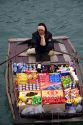 Vendors in boats selling snack food to tourists in Ha Long Bay, Vietnam.