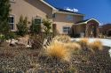 Xeriscaping using rock and native grass to conserve water at a residential home in Boise, Idaho, USA.