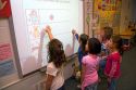 Kindergarten students use an interactive whiteboard in the classroom of a public school in Boise, Idaho, USA. MR